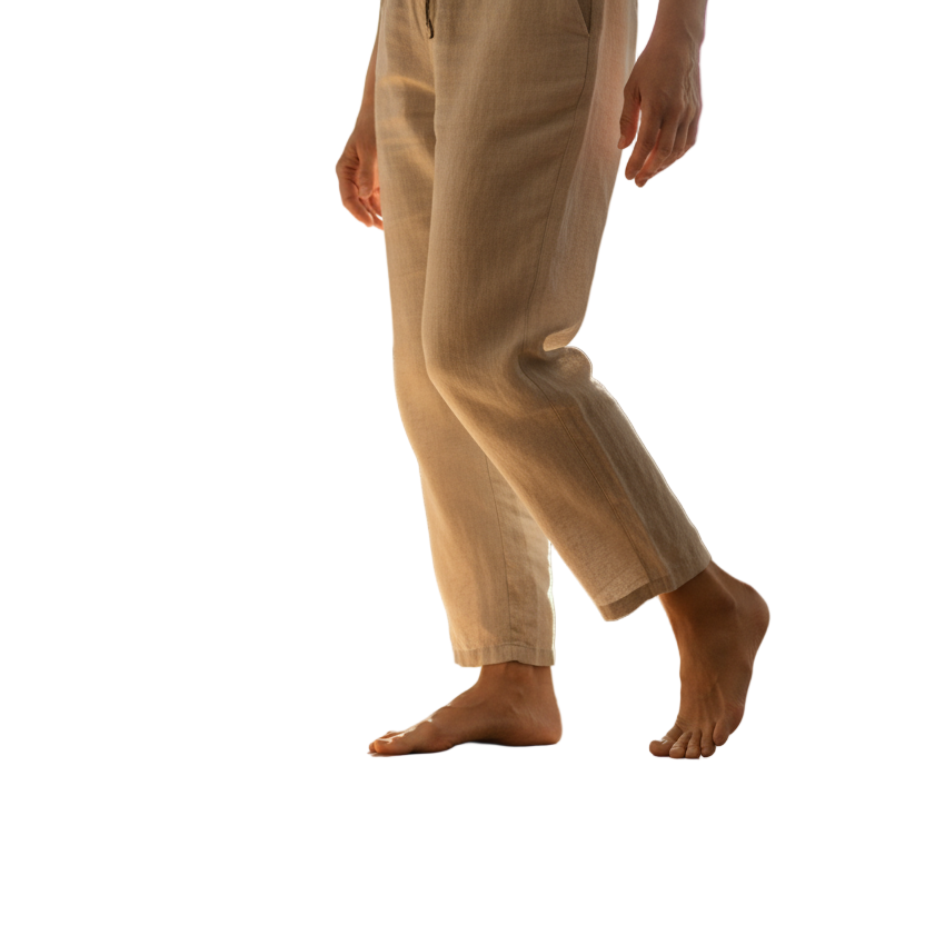 Create a high-quality, realistic lifestyle image for a wellness brand.
A calm middle-aged person (around 45–60 years old) standing barefoot on a wooden floor in natural light, stretching or walking comfortably.
Soft neutral background, warm daylight tones.
The image should express freedom, relief, and natural movement — not clinical or medical.
Composition: minimalistic, clean, with focus on legs and posture, not face.
Brand aesthetic: modern, trustworthy, gentle, and premium.
Use color harmony matching #00